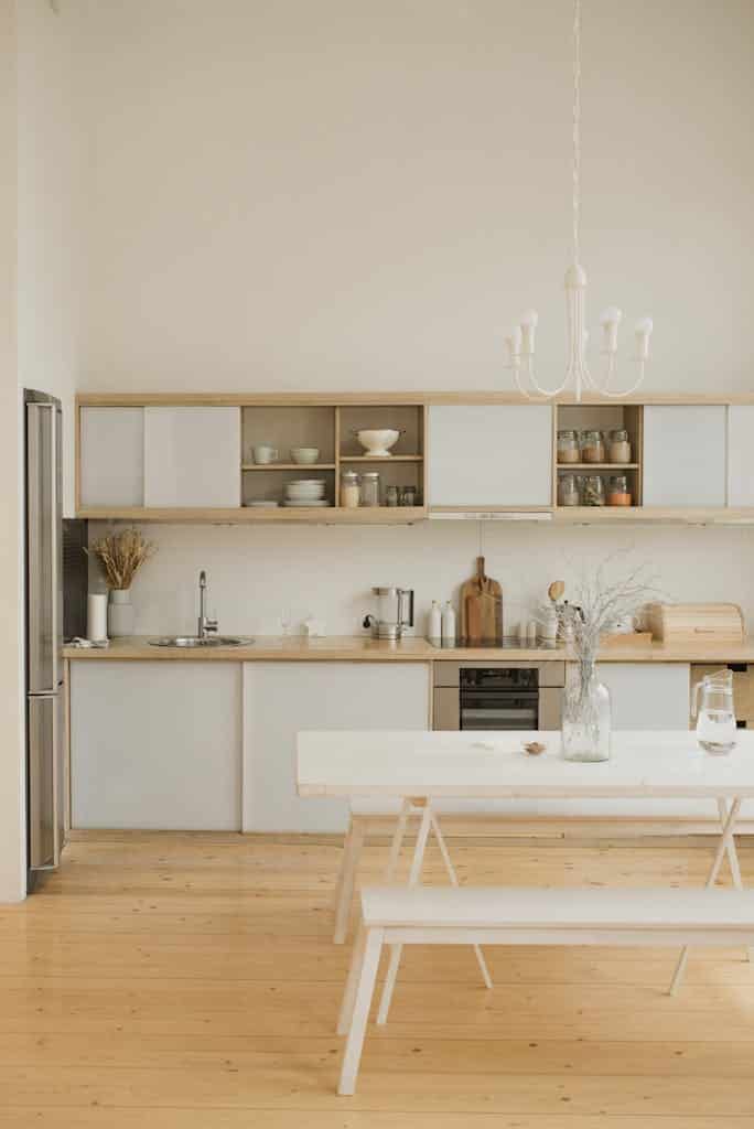 Stylish kitchen interior with minimalistic design and modern wooden elements.